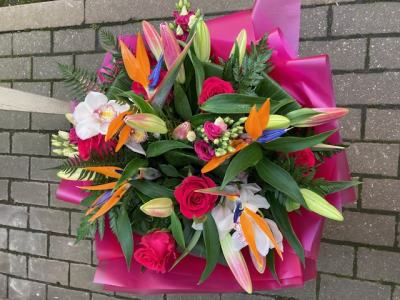Vibrant Vibes - Strong and vibrant design consisting of a mixture of tropical and long lasting flowers with complementing foliage. The design will vary depending on availability .