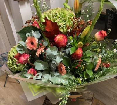 Autumn Delight - This design will be created using rich chocolate, red, orange , peach and green toned flowers with natural leaves and grass that will compliment any habitat.