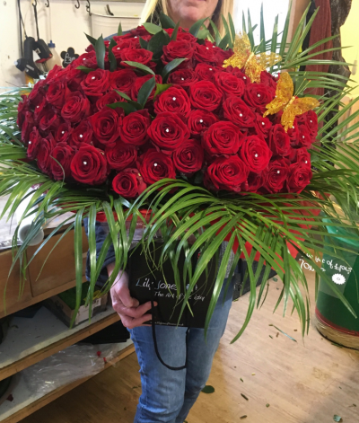 Valentine Special - We will design a beautiful hand tie arrangement of 100 of our best quality red roses.